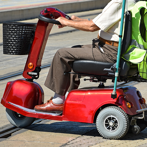 older man using mobility scooter